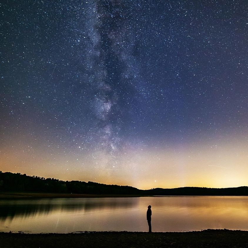 human looking up at milky way