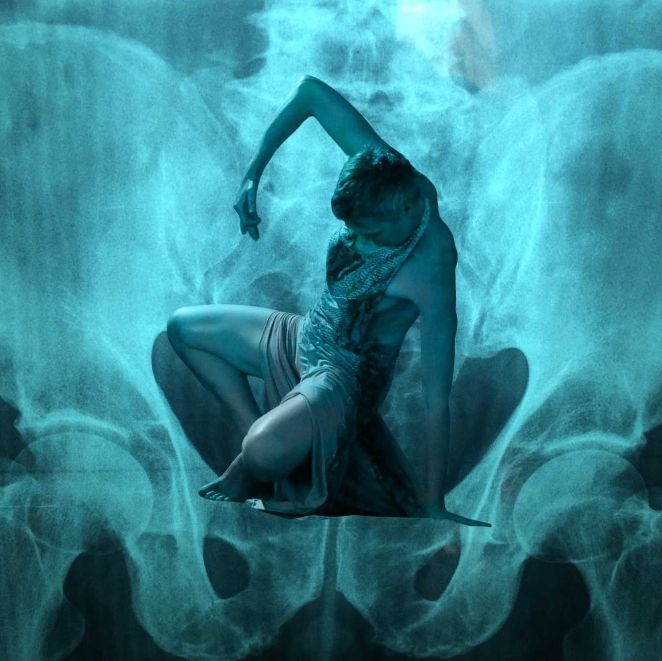 dancer unfolding upwards inside of x-ray of human pelvis
